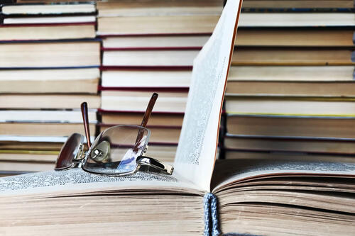 glasses on open book