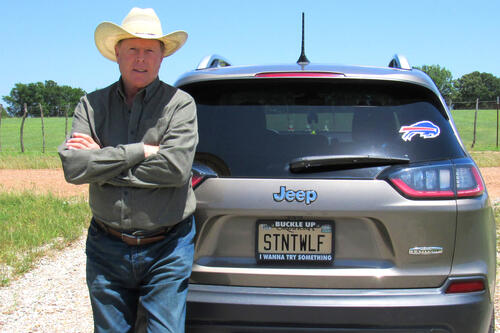 Brian Hossenlopp-Dakota ’77 in front of a car.