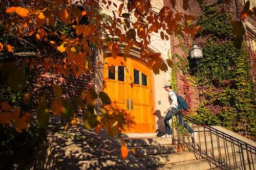 A student enters Sturges Hall in the fall.