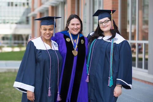 Tanairi Taylor, left, and Terese Caiazza, far right, are the first to graduate as women's and gender studies majors. Professor of English and Music Melanie Blood is with them.