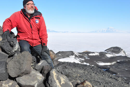 Adjunct Lecturer in the Department of English Glenn McClure '86/M.S.Ed. '11, looks out over the landscape in Antarctica. Photo by Elaine Hood, U.S. Antarctic Program, National Science Foundation