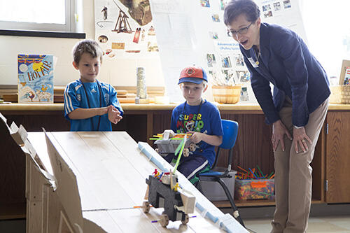 SUNY Geneseo President Denise A. Battles with young students.