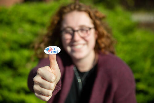 Student with an "I Voted" sticker.