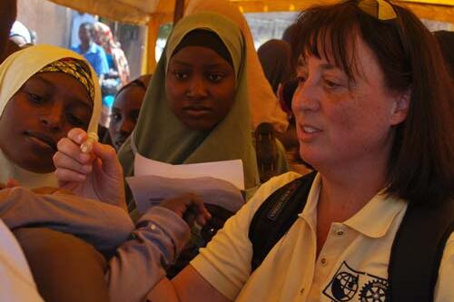 Colleen Bonadonna '93 gives the polio vaccine to children.