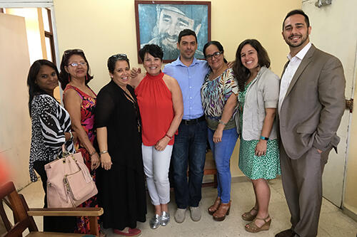 Sam Cardamone, associate director of the Study Abroad Office, at right, and Melanie Medeiros, assistant professor of anthropology, second to right, with representatives in Cuba. 