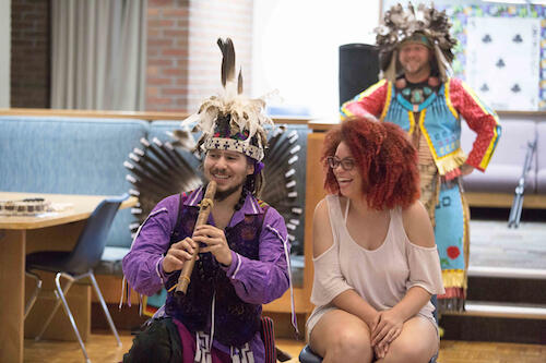 Redhawk Native American Arts Council performers with a Geneseo student.