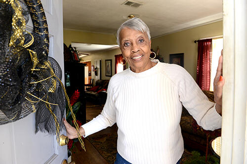 Daisy Guyton at her home opening the door.