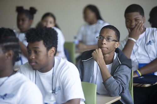 Student in Camp College listens during a session.