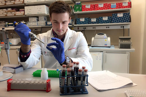 Gregory Roloff '12 at the NIH testing a sample.