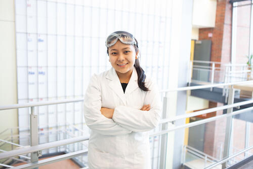 Pema Sherpa in a lab coat in the Integrated Science Center