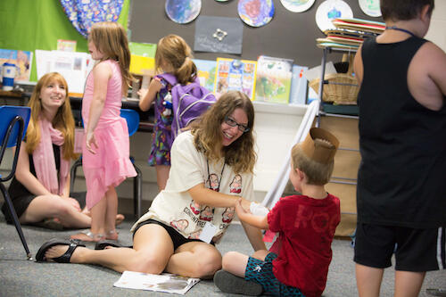 A student works with a Soaring Stars participant.