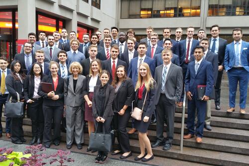 School of Business students and faculty on the steps of a firm in NY.