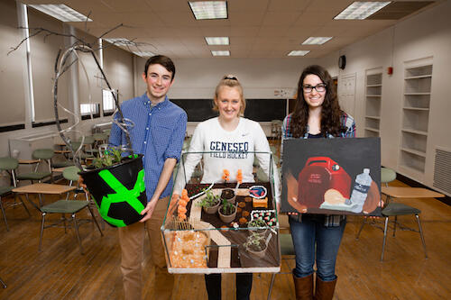 Ethan Smith '20, Ariana Walczyk '19 and Sara Feinland '19 show their art projects for the course. 