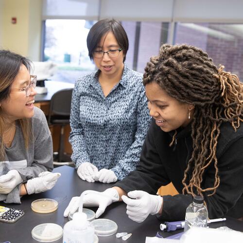 Suann Yang, associate professor of biology, with two biology students.