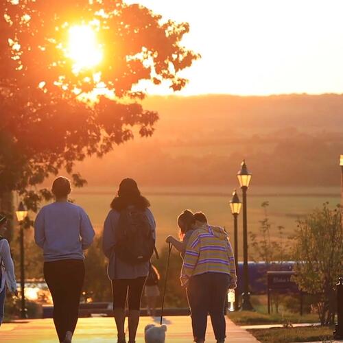 Students on campus during sunset