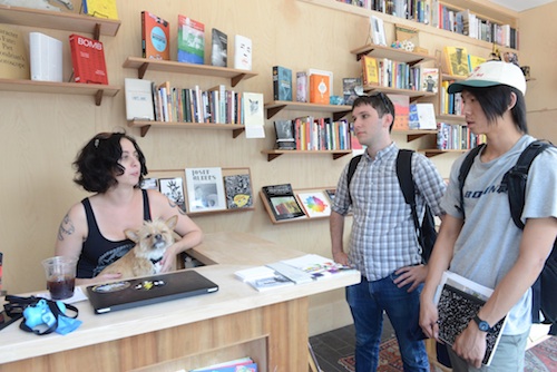 Students interview a bookstore employee about life in Red Hook