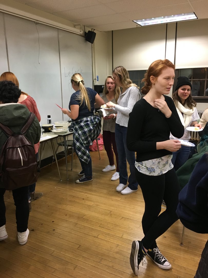 Students standing throughout the room.