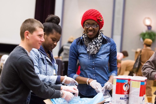 Students filling bags for soup at the day of service.