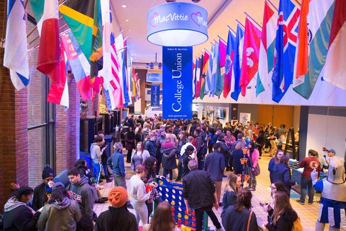 macvittie-college-union-2018 Large crowd of students and staff in the College Union, talking together and playing games.