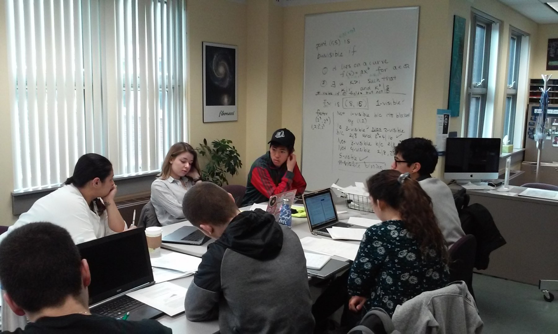 Dr. Pamela Harris lead a group of students working on a problem on Invisible Lattice Points.