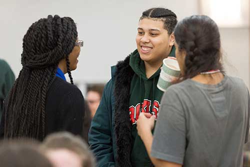 Students mingle during the Mardi Gras celebration.