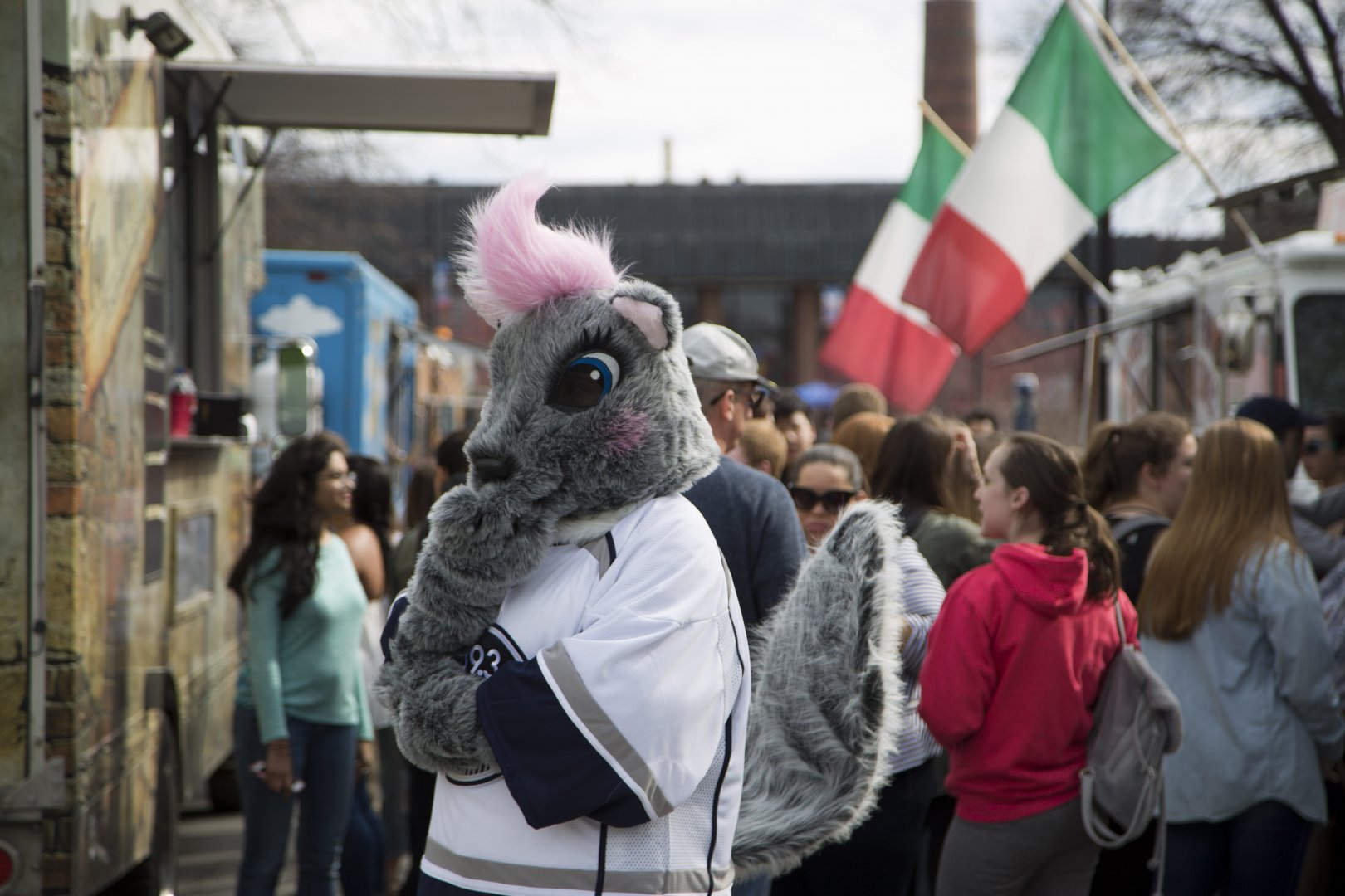 Genny in the crowded food truck area, wondering which truck to visit.