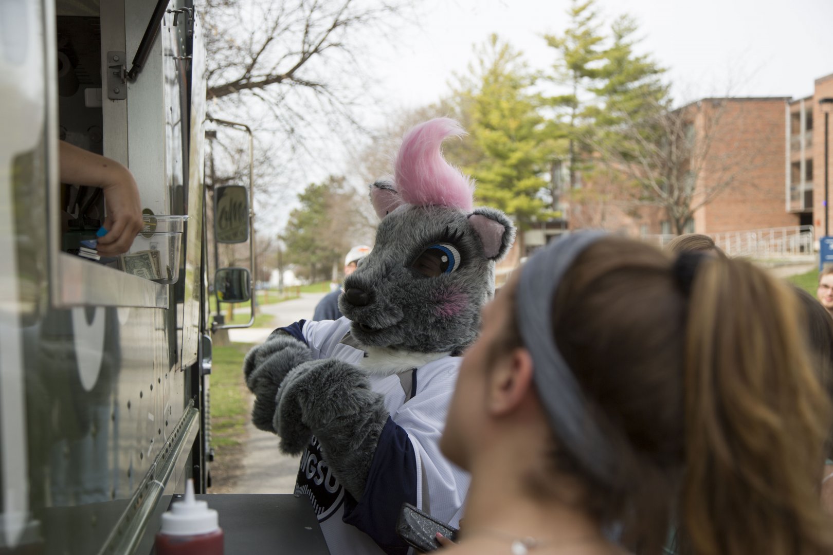 Genny ordering a second plate at a food truck.