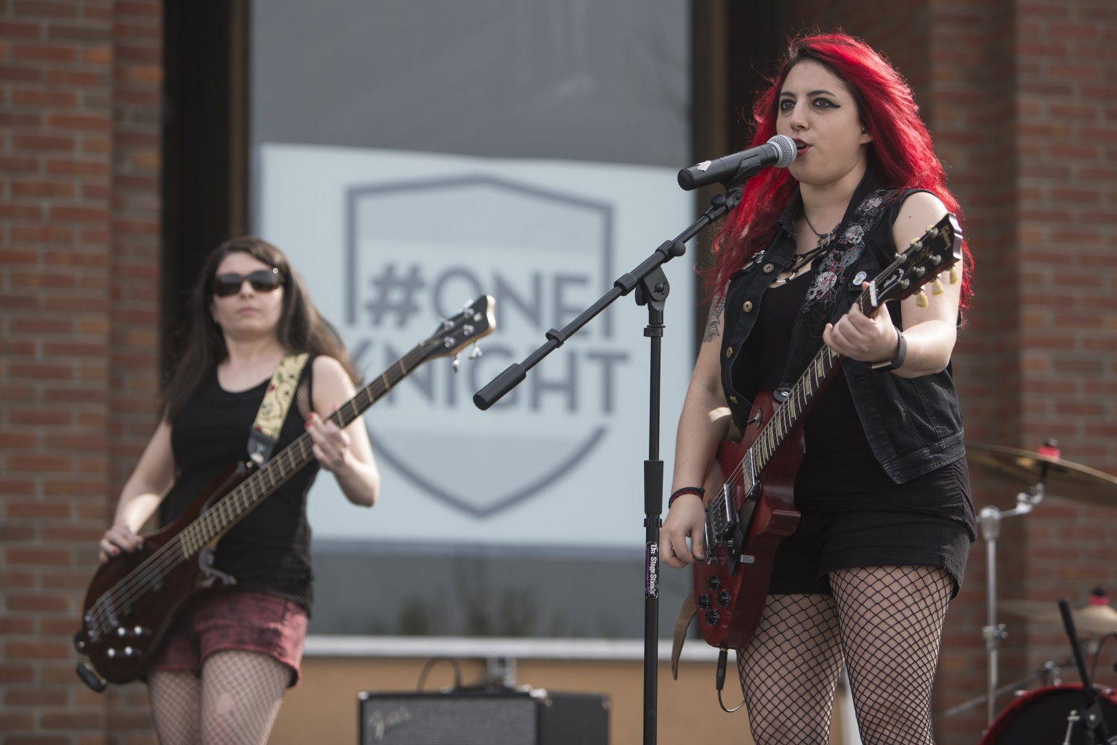 A closer shot of Jackknife Stiletto. The photo shows two artists performing with guitars, with one of them also singing.