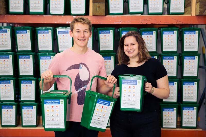 Alec Ritter '20 and Clara Gallagher '20 stand with the composting bins.