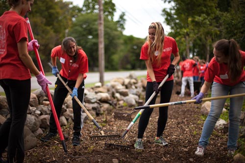 students raking leaves
