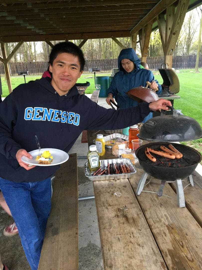 PRISM Math Club: A student presenting hotdogs on a grill