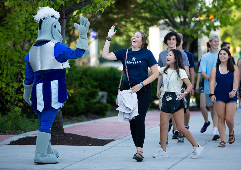 Knight mascot high-fives students