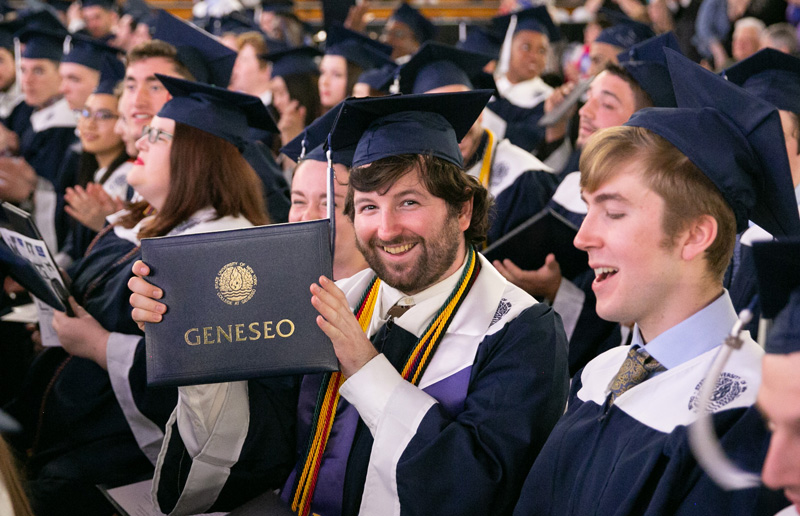 Student holding diploma at Commencement