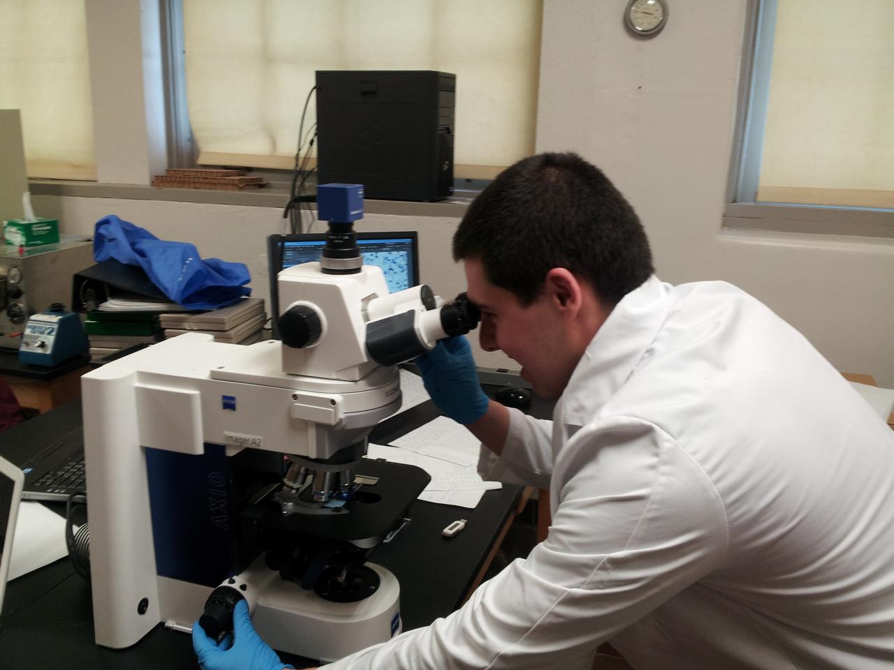 Man working on microscope