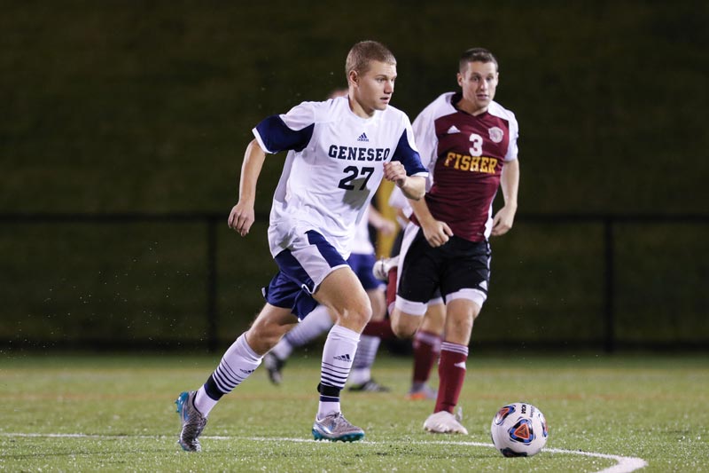 A SUNY Geneseo men's soccer player preparing to kick a ball A SUNY Geneseo men's soccer player preparing to kick a ball