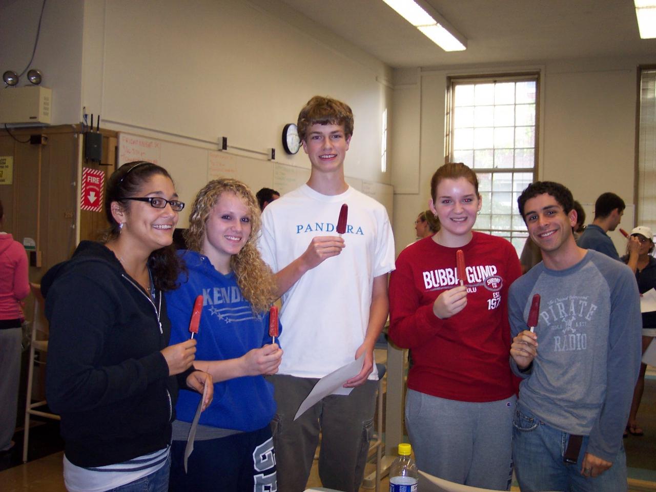 PRISM Math Club: Student smile as they grab plates for food