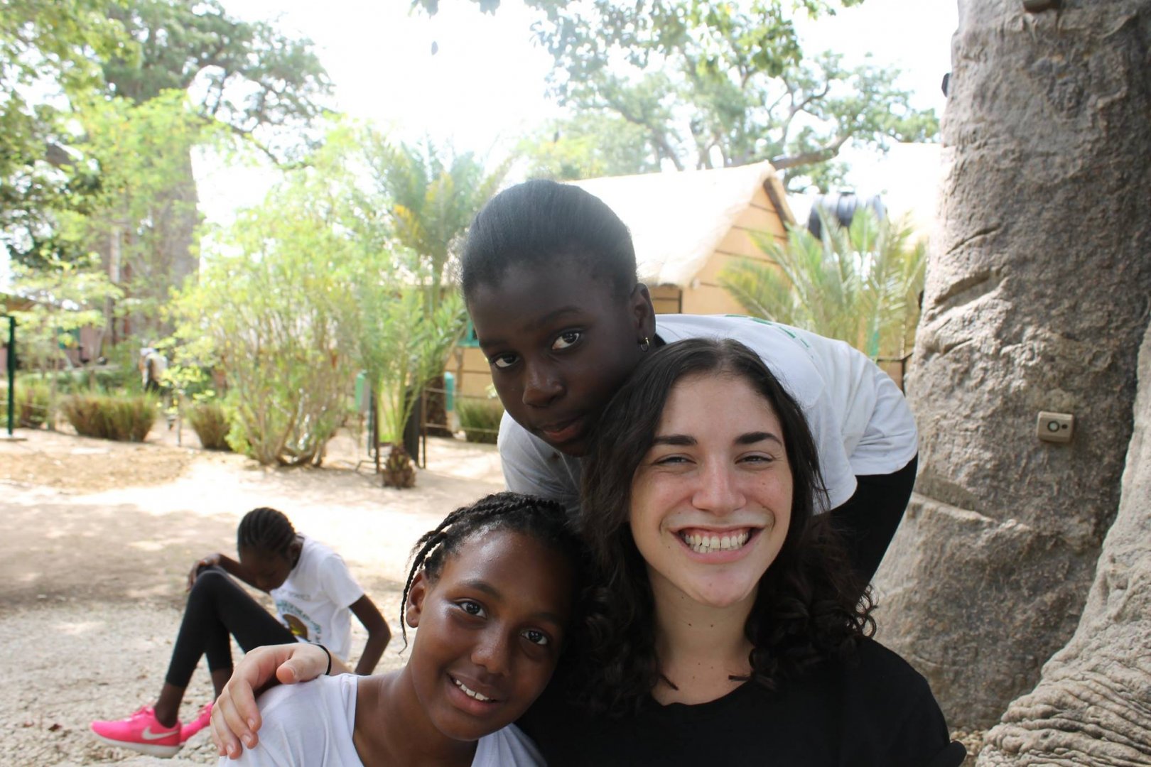 People sitting next to a tree