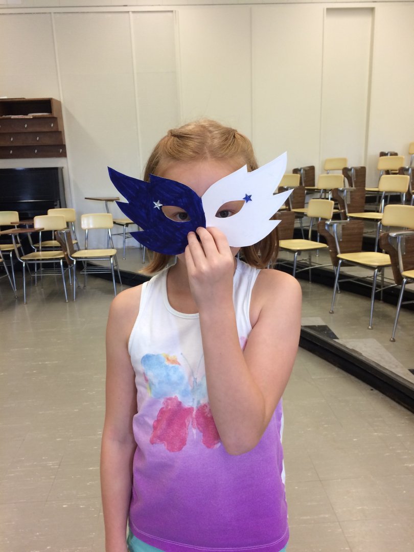 Girl holding up mask