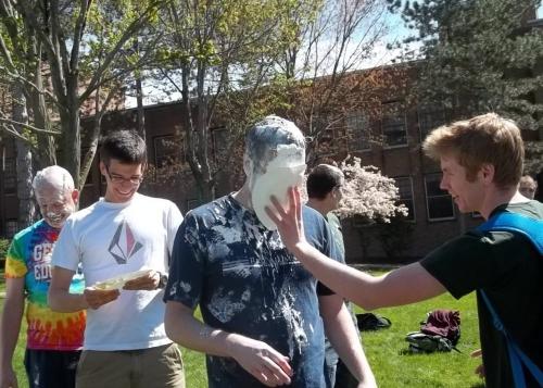 standing professor getting pied