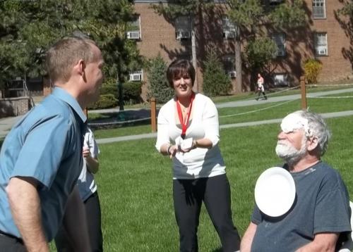 professor with pie plate falling off his face