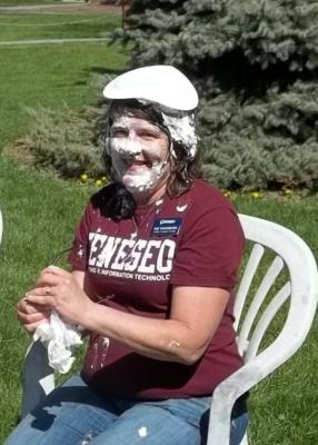 student with pie on her head