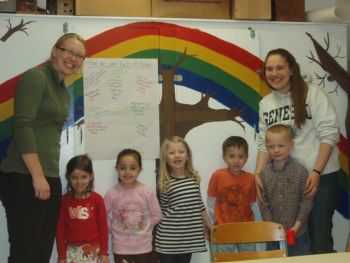 Two students and a group of children