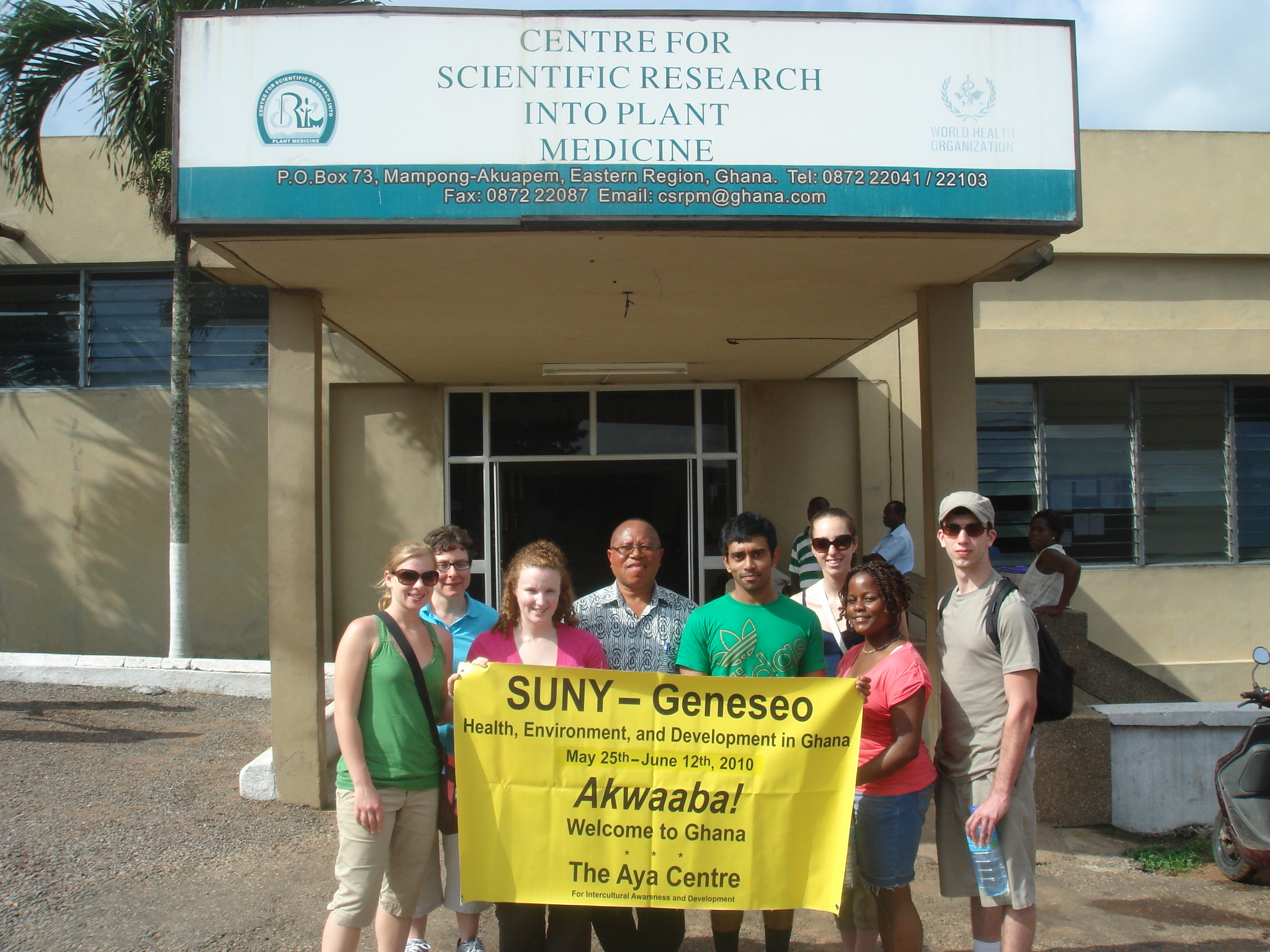 group photo in front of center for scientific research into plant medicine