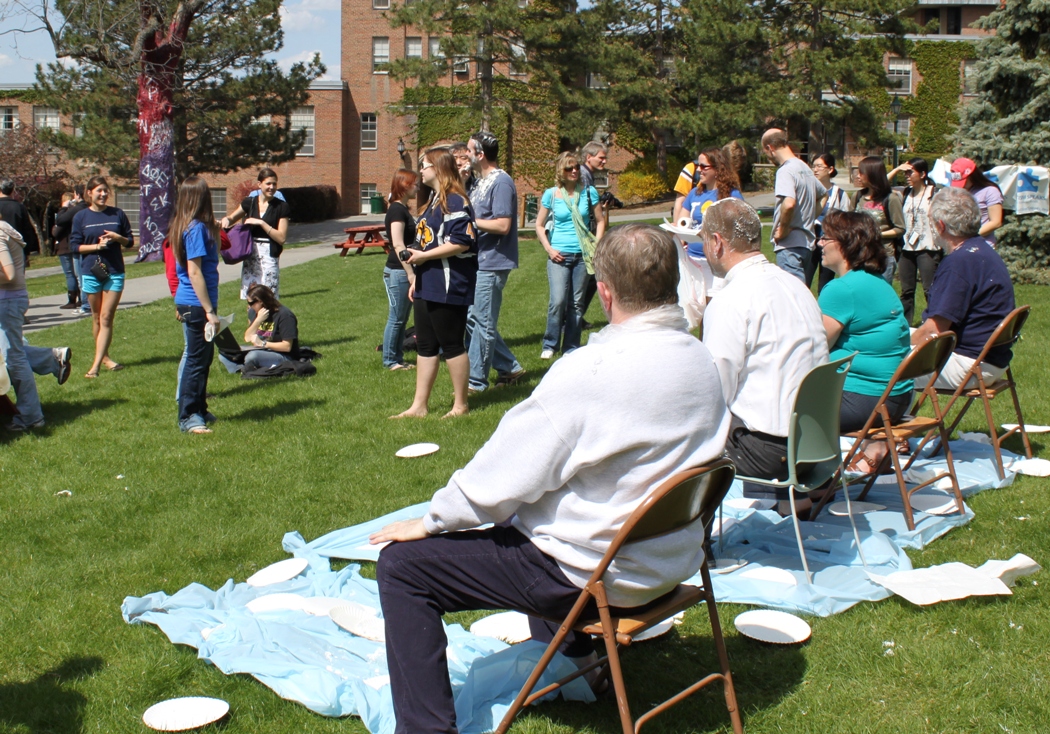 Pi in the face for autism event: students with pies