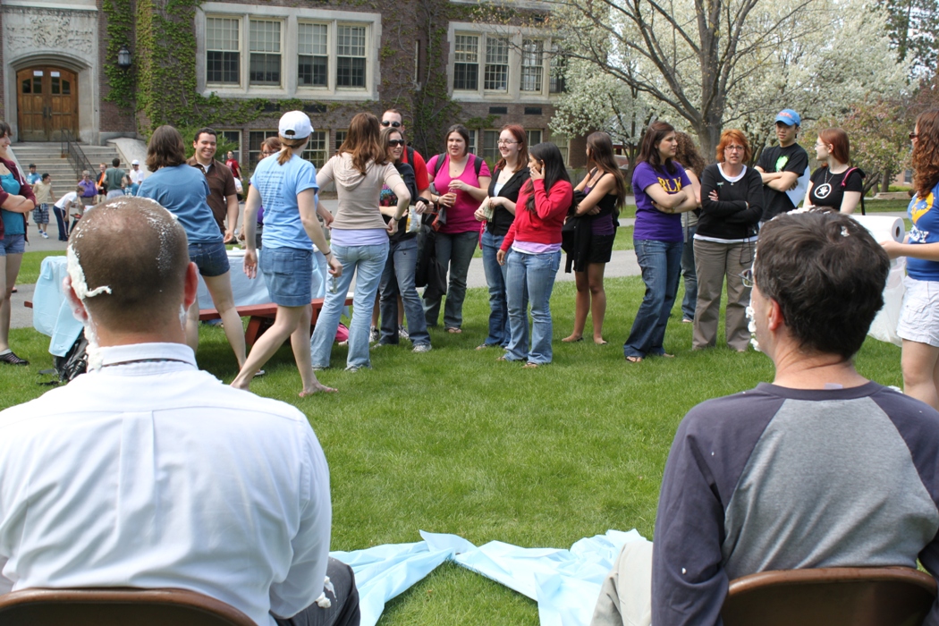 Pi in the face for autism event: students around pinic table