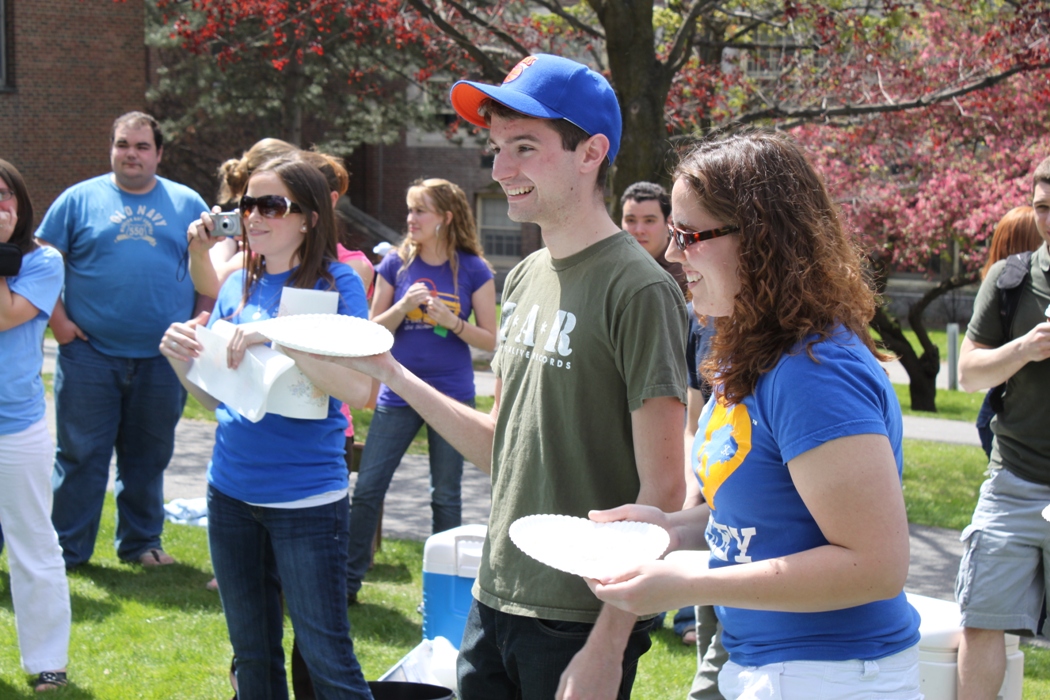 Pi in the face for autism event: teacher and students laughing