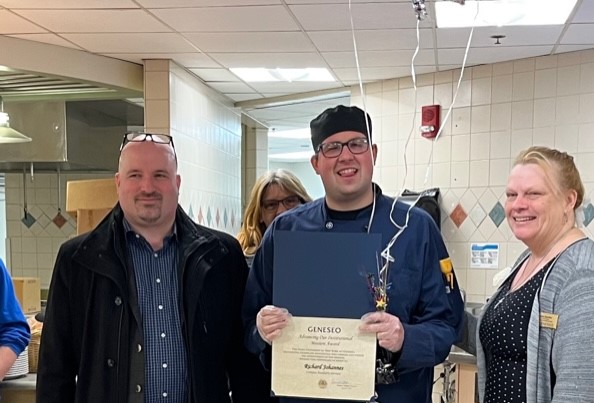 Ricky Johannes, center, with his award.