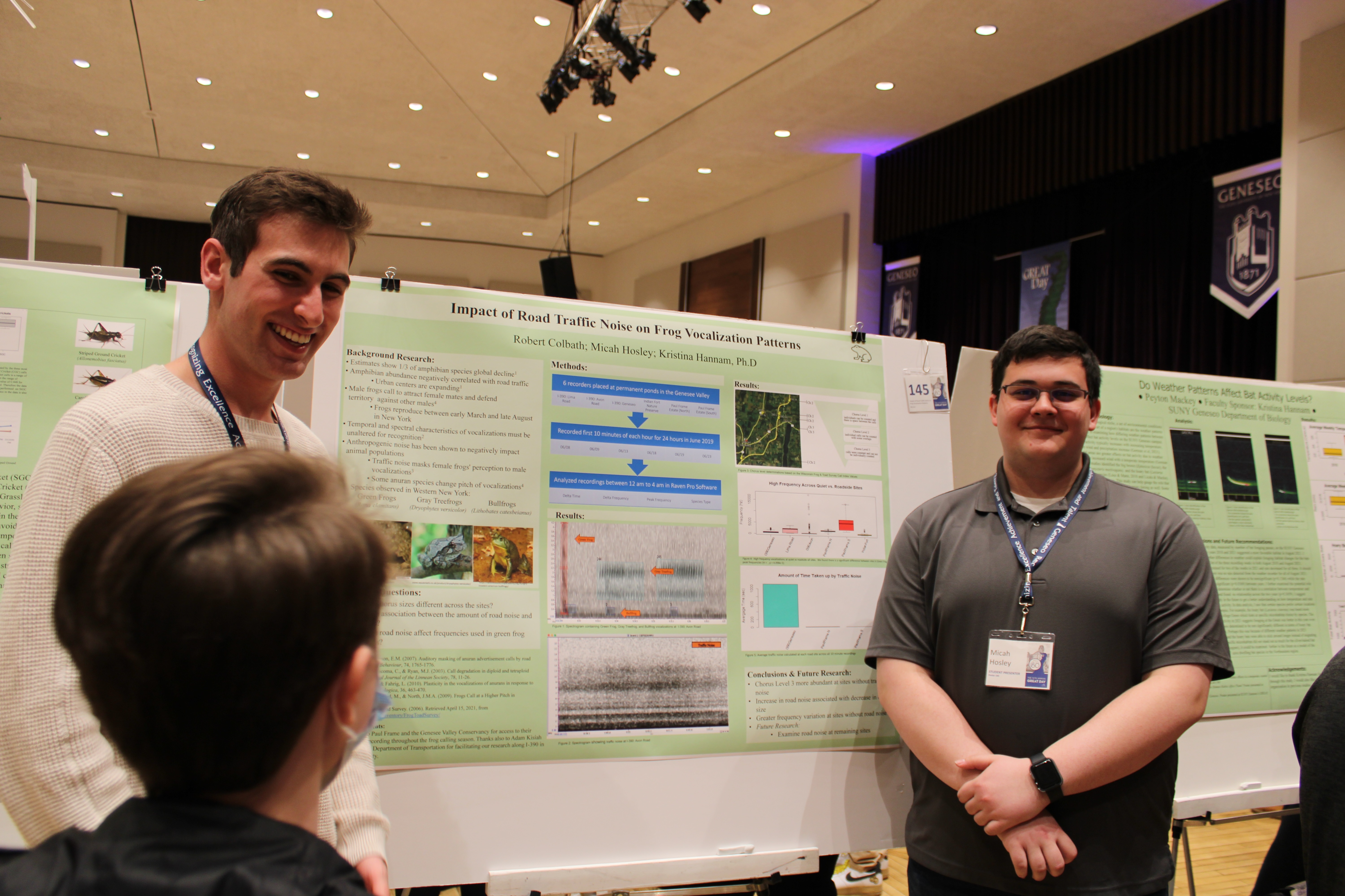 great Students speaking to people about their posterboard on the effect of traffic noise on frogs.