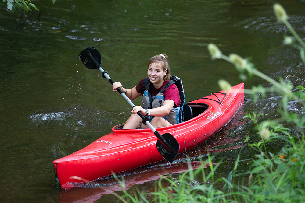 student kayaking