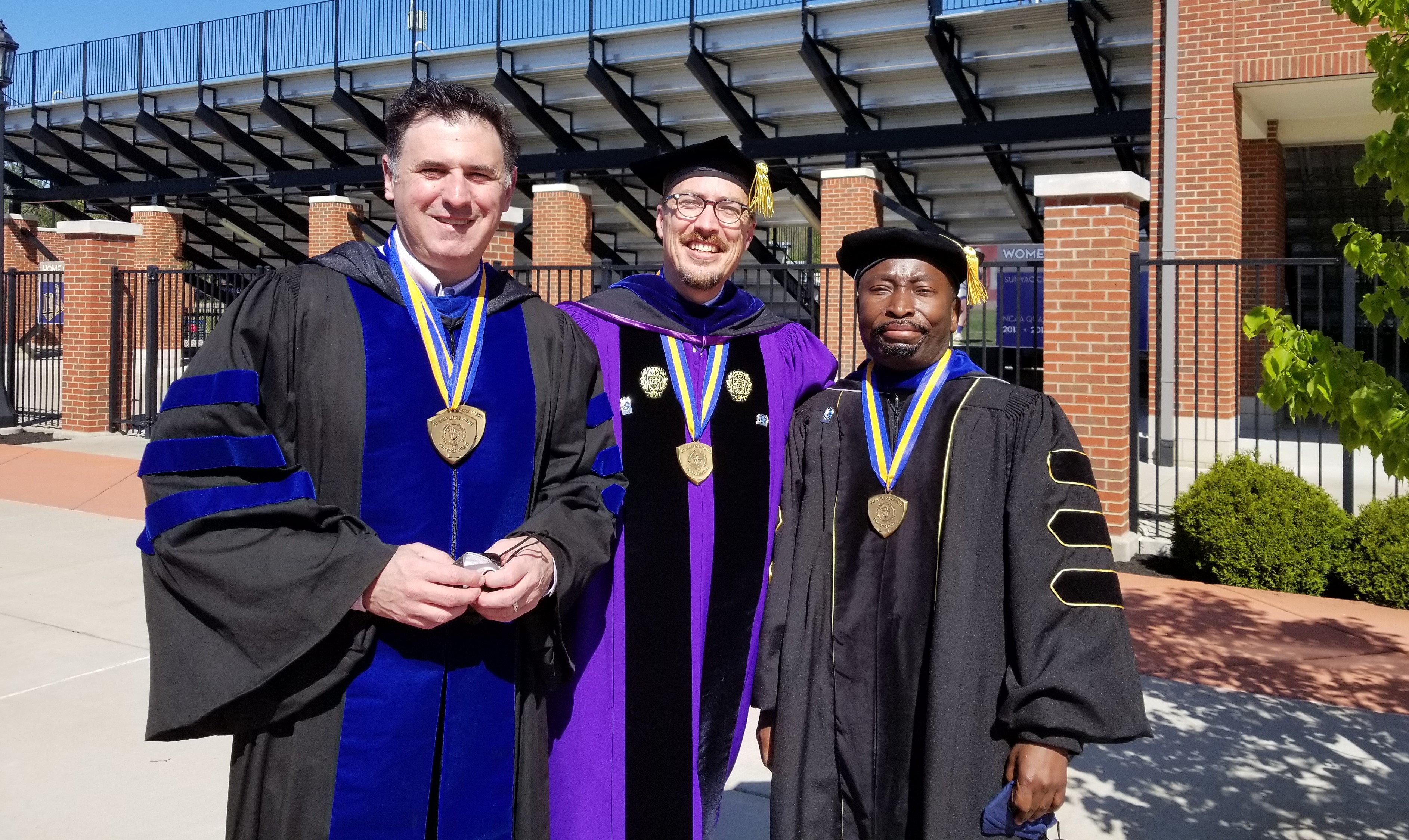 Photo of Drs. Adabra, Behrend, and Doggett in regalia.